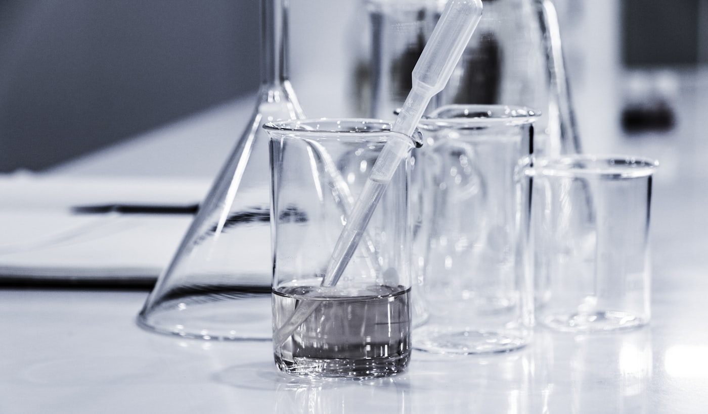three clear beakers placed on tabletop